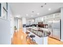 Bright kitchen features stainless steel appliances, sleek black countertops, and an island with barstool seating at 333 W Trade W St # 1302, Charlotte, NC 28202
