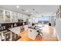 Modern kitchen has stainless steel appliances, black countertops, white cabinets, and hardwood floors throughout at 333 W Trade W St # 1302, Charlotte, NC 28202