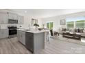 Bright open-concept kitchen featuring modern appliances and a seamless flow to the living area at 3543 Cramer Creek Dr, Gastonia, NC 28056