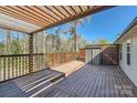 Spacious, updated wood deck with pergola, stained wood railings, and storage shed at 3753 Capps Hill Dr, Charlotte, NC 28216
