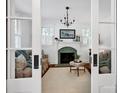 Elegant living room featuring a decorative fireplace, hardwood floors, and ample natural light at 411 Walnut St, Davidson, NC 28036