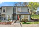 Charming gray two-story townhouse featuring a small garden, wood stairs, and a red front door at 4340 N Center Ne St # 508, Hickory, NC 28601