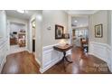 Inviting hallway featuring hardwood floors, elegant wainscoting, and an open view into the adjacent living spaces at 45008 Wigeon Ln # 101, Indian Land, SC 29707