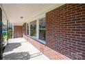 Inviting covered porch with classic brick detailing and ample space for relaxation at 521 Hawthorne Ln, Gastonia, NC 28054