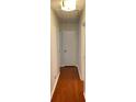 Hallway with wood floors and white door at 7412 Broken Oak Ln, Charlotte, NC 28226