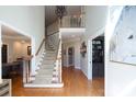 Grand foyer features hardwood floors, soaring ceilings, and a staircase with white wood railing at 880 Craigmont Nw Ln, Concord, NC 28027