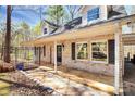 Welcoming entrance featuring a brick facade, black shutters, and an iron gate detail at 9200 Surrey Rd, Mint Hill, NC 28227