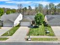 Inviting single-story home with lush green lawn, attached garage, and close proximity to neighboring houses at 9209 Tibble Creek Way, Charlotte, NC 28227