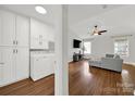 Open concept living area with hardwood floors, a ceiling fan, and plenty of natural light at 9209 Tibble Creek Way, Charlotte, NC 28227