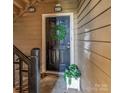 Welcoming front door with wreath and a charming potted plant, creating a warm entrance at 1101 E Morehead St # 31, Charlotte, NC 28204