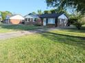 View of the home from the front yard showing the home's brick exterior and mature landscaping at 1108 Pearson Dr, Rock Hill, SC 29730