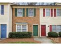 Townhomes featuring brick and siding facades with colorful shutters and doors at 1113 Keswick Pl # 118, Monroe, NC 28112