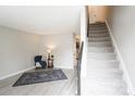 Cozy living room with modern flooring, plush rug, and staircase access at 1113 Keswick Pl # 118, Monroe, NC 28112