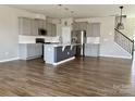 Spacious open kitchen with grey cabinetry, an island with a sink and stainless steel appliances at 11220 Westbranch Pkwy, Davidson, NC 28036