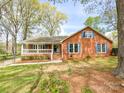 Traditional brick home with a welcoming front porch and eye-catching blue shutters at 12011 Stoney Meadow Dr, Mint Hill, NC 28227