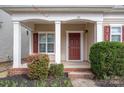 Inviting front porch with decorative columns, brick steps, and colorful landscaping at 125 Colville Rd, Mooresville, NC 28117