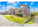 Beautiful two-story home featuring a front porch, complemented by lush green lawn and sidewalk at 12706 Heath Grove Dr, Huntersville, NC 28078