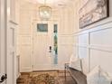 Bright foyer showcasing a stylish chandelier, decorative woodwork, and elegant decor at 12912 Bailey Rd, Cornelius, NC 28031