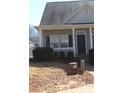 Charming home featuring a covered porch, complemented by neat landscaping and a welcoming entrance at 13016 Meadowmere Rd, Huntersville, NC 28078
