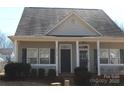 Inviting home exterior with a covered porch, offering curb appeal and a cozy entrance at 13016 Meadowmere Rd, Huntersville, NC 28078
