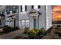 Charming townhouse with a light blue front door, attached garage, and neatly manicured shrubbery at 13304 Porter Creek Rd, Charlotte, NC 28262