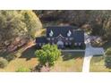 Overhead aerial shot showcases a two-story brick home, with a long driveway and well-maintained landscaping at 14124 Hiwassee Rd, Huntersville, NC 28078
