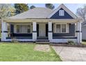 Inviting single-story home with a classic covered front porch, painted brick columns, and manicured lawn at 209 N Yadkin Ave, Spencer, NC 28159