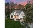Areal view of two-story home with well manicured yard, two-car garage, and mature trees at 209 Sardis Ln, Charlotte, NC 28270