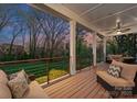 Covered back porch featuring outdoor seating and views of the manicured backyard at 209 Sardis Ln, Charlotte, NC 28270