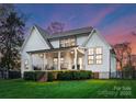 A spacious covered back porch with stairs to a lush, level yard creates an inviting outdoor retreat at 209 Sardis Ln, Charlotte, NC 28270