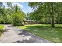 Well-maintained home surrounded by lush greenery, offering privacy and a serene setting at 2681 University Dr, Lancaster, SC 29720