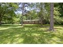 Beautiful home nestled among mature trees, providing shade and a peaceful atmosphere at 2681 University Dr, Lancaster, SC 29720