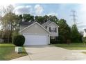 Charming two-story home featuring manicured front yard and attached two-car garage with large driveway at 2919 Bridgeville Ln, Charlotte, NC 28262