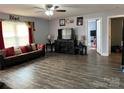 Spacious living room with wood-look floors, comfortable seating, and a large entertainment center at 300 S Oakland Ave, Statesville, NC 28677