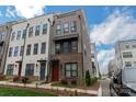 Attractive multi-story townhome featuring modern design and manicured front yard at 3105 Beans Blvd, Charlotte, NC 28203