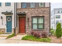 Welcoming townhouse entrance with a brick facade and colorful landscaping at 3105 Beans Blvd, Charlotte, NC 28203