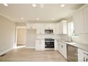 Bright kitchen featuring white cabinets, stainless steel appliances, and modern countertops at 333 City Ave, Lancaster, SC 29720