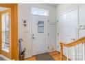 Bright entryway featuring a white door, coat hooks, and a staircase at 4039 Holly Villa Cir, Indian Trail, NC 28079