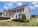 Well-maintained townhome exterior with neat landscaping and a visible row of similar houses at 4039 Holly Villa Cir, Indian Trail, NC 28079