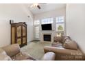 Spacious living room with vaulted ceilings, a fireplace, and plenty of natural light at 4039 Holly Villa Cir, Indian Trail, NC 28079