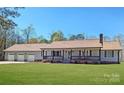 Charming single-story home with a welcoming front porch and well-maintained lawn, highlighting its curb appeal and inviting atmosphere at 4487 Catawba Burris Rd, Denver, NC 28037