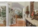 Inviting foyer with hardwood floors, elegant staircase, and decorative accents at 4586 Chanel Ct, Concord, NC 28025