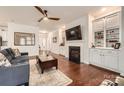 Inviting living room with hardwood floors, built-in cabinets, fireplace, and plenty of natural light at 525 Cellini Pl, Mount Holly, NC 28120