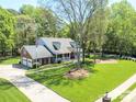 Beautiful home with a spacious yard, complemented by mature trees and a lengthy driveway at 5344 Saddlewood Ln, Mint Hill, NC 28227