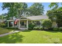 Charming single-story house featuring a covered porch with rocking chairs and swing at 5400 Glenham Dr, Charlotte, NC 28210