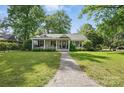 Charming single-story home with well-maintained lawn and brick pathway at 5400 Glenham Dr, Charlotte, NC 28210