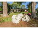 Alluring home displaying blooming flowers in a landscaped yard with mature trees and a covered front porch at 631 Dogwood Rd, Statesville, NC 28677