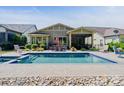 Backyard pool with stone surround, outdoor dining area, and a screened-in porch for relaxing by the pool at 650 Tallulah Falls Dr, Denver, NC 28037