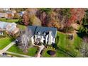 An aerial view of a home with a well-manicured lawn, mature trees, and impeccable landscaping at 708 Ridgelake Dr, Weddington, NC 28104