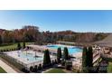 Beautiful community pool featuring pergolas, a splash pad, and mature trees offering a relaxing outdoor oasis at 708 Ridgelake Dr, Weddington, NC 28104